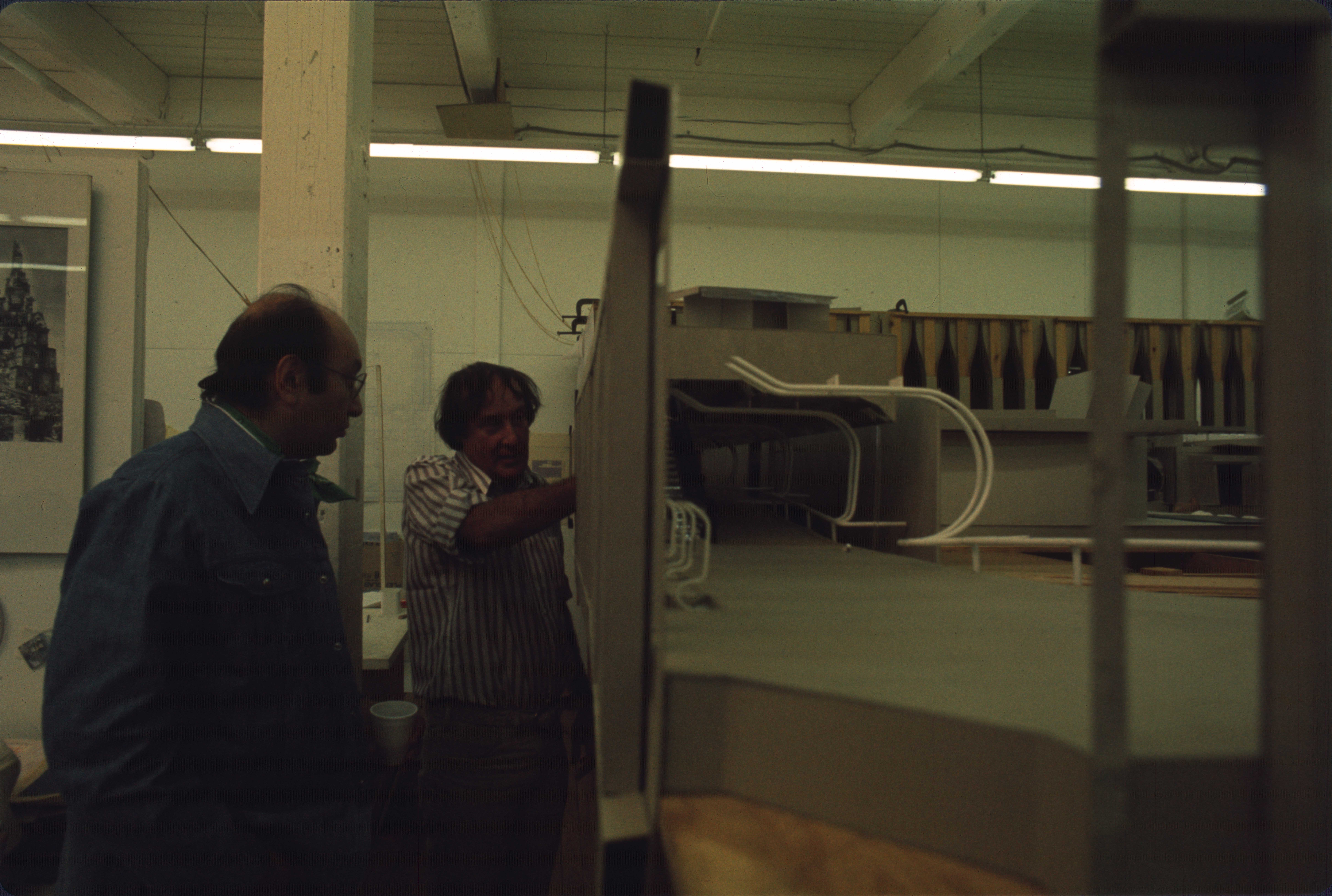 two men looking at an architectural model